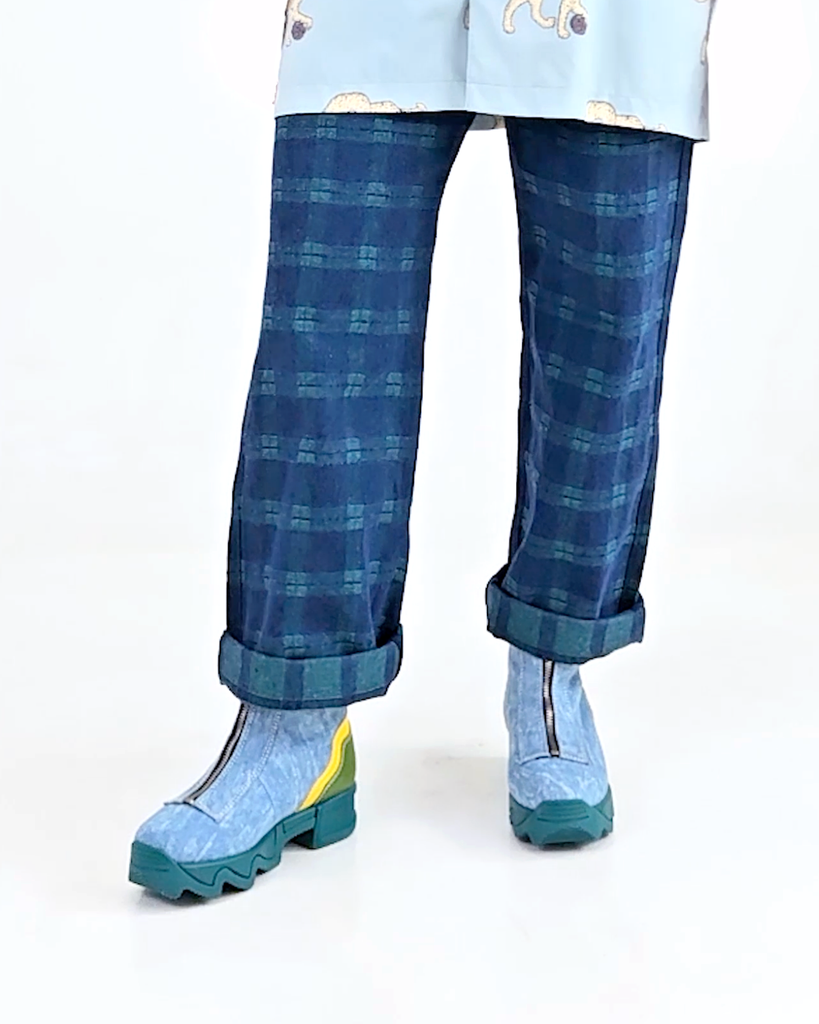 Model wearing beautiful ODELE boots. iRi ODELE Multi zip up boot detail shot whimsical multicolor recycled materials sustainable